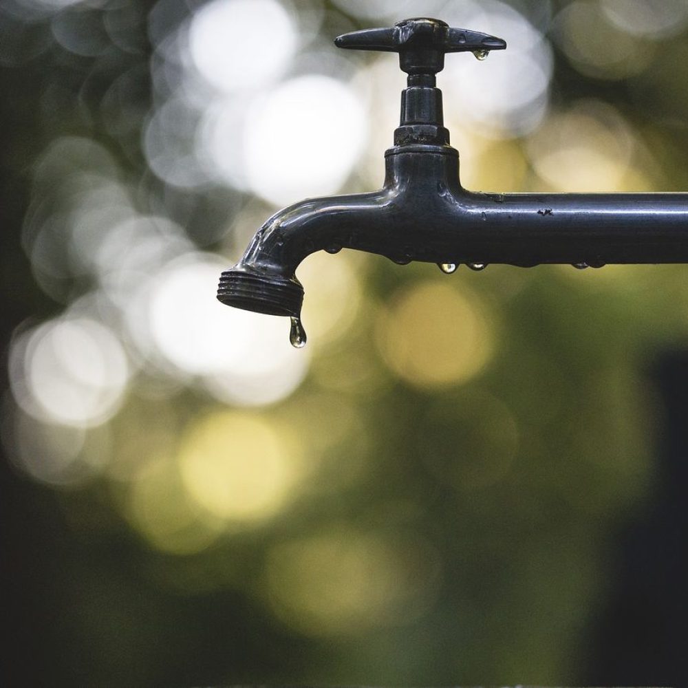 Outdoor tap faucet drips with water. Original public domain image from Wikimedia Commons