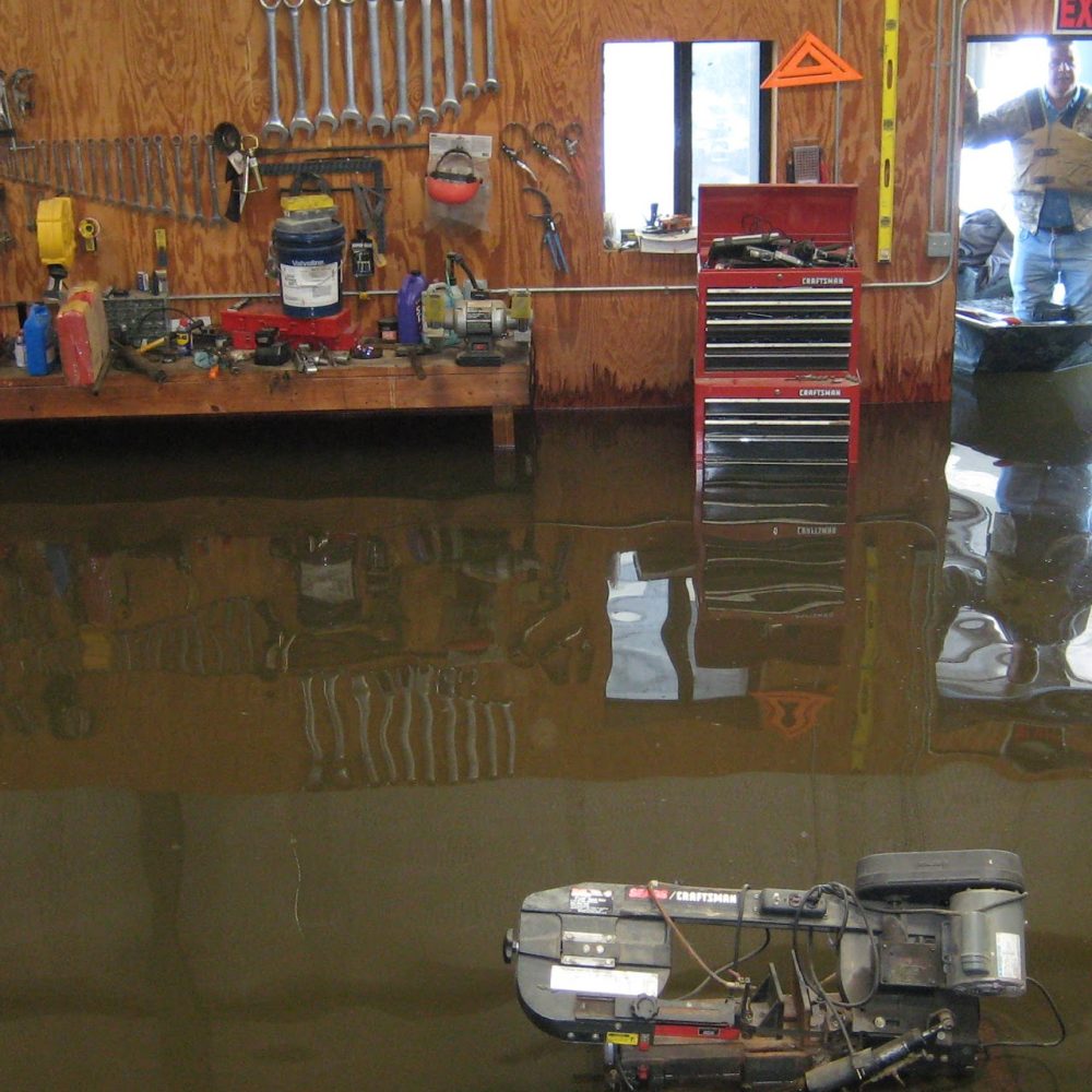 Bald_Knob_National_Wildlife_Refuge_Manager_Robert_Alexander_Uses_a_Boat_to_Inspect_Water_Damage_at_the_Refuge_Shop_(5759056404)